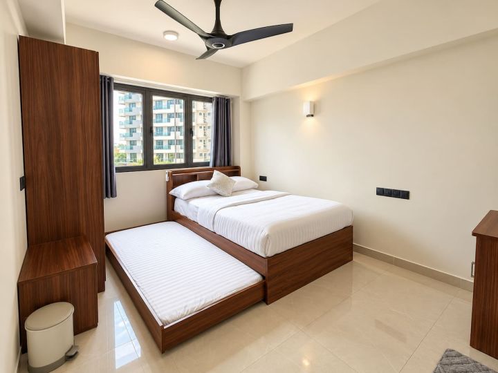 Bedroom with queen bed and single trundle bed