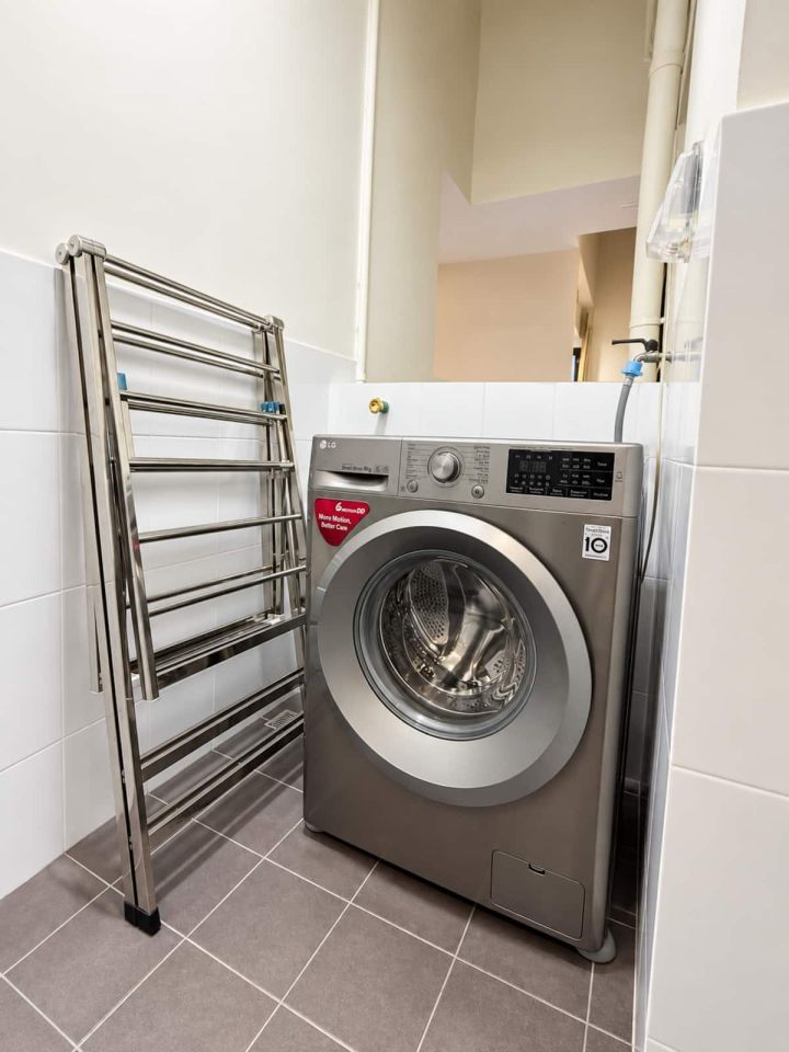 Laundry area with washing machine and drying rack