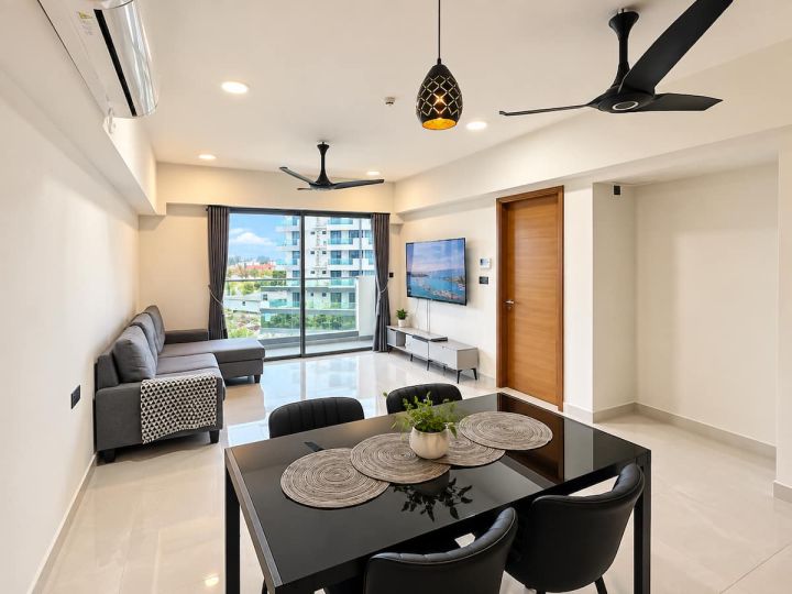 Living room with sofa, TV and dining table